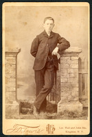 Portrait of a boy in a suit taken by photographer T. D. Lewis of Kingston, New York.