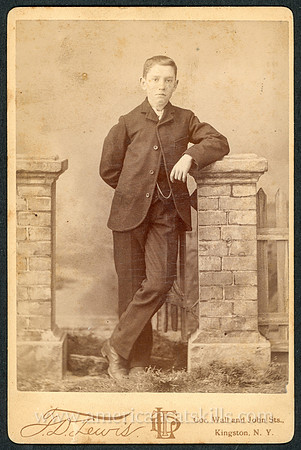 Portrait of a boy in a suit taken by photographer T. D. Lewis of Kingston, New York.