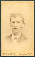 Portrait of a young man in a suit taken by photographer T. D. Lewis of Kingston, New York.