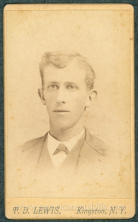 Portrait of a young man in a suit taken by photographer T. D. Lewis of Kingston, New York.