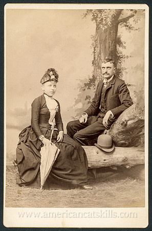 Portrait of a well-dressed couple taken by the photographic firm of Towne & Elwell of Tannersville, New York.