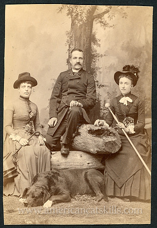 Portrait of a group of friends with their dog taken by the photographic firm of Towne & Elwell of Tannersville, New York.
