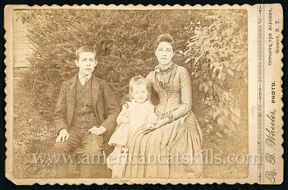 Family portrait of Charlie, Bertha and Hattie Phelps taken by photographer Ralph B. Wheeler of Sidney, New York.
