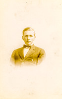Portrait of a young man in a suit by photographer Howard Wood of Hurleyville, New York.